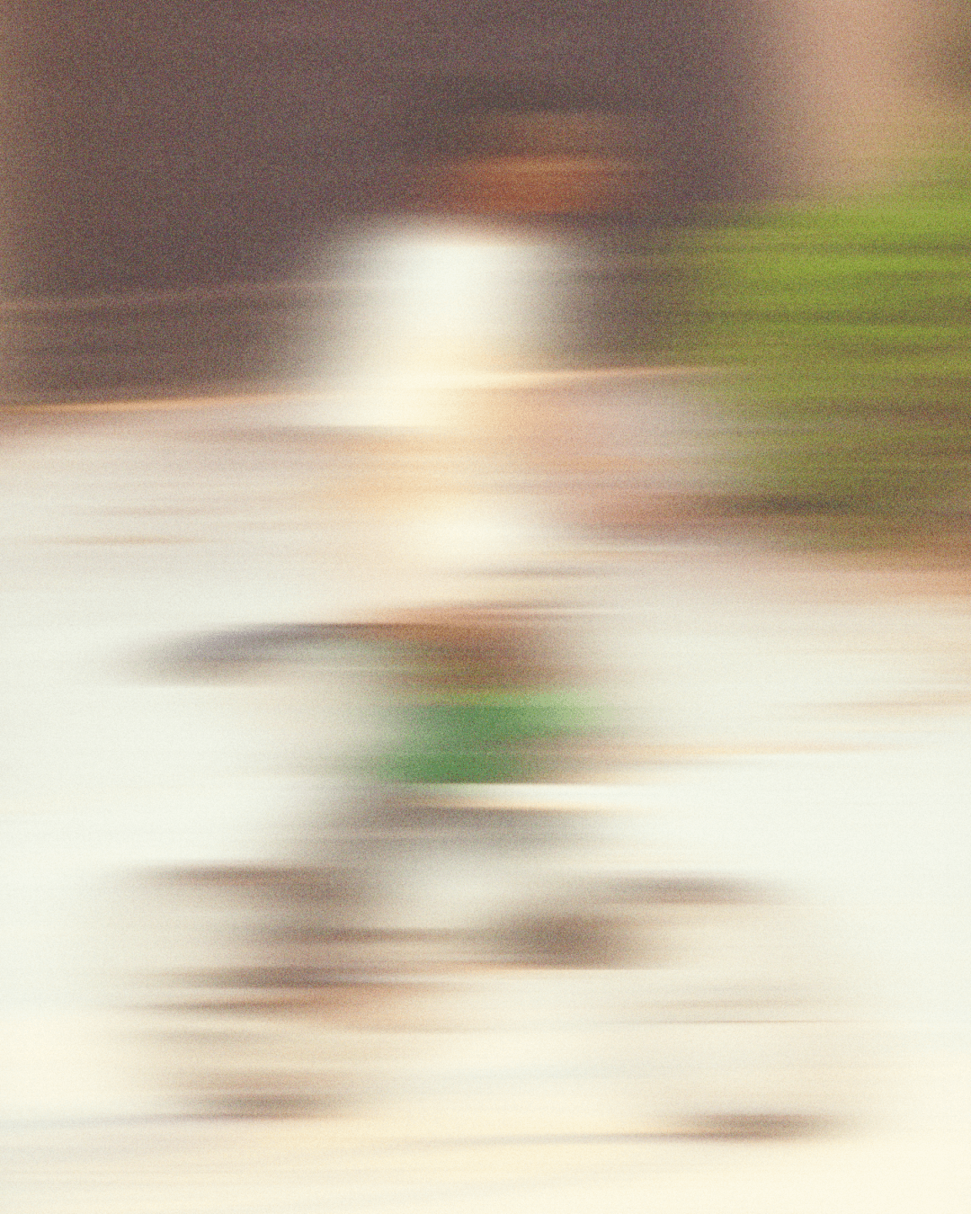 Person sitting on floor reading a book in natural light