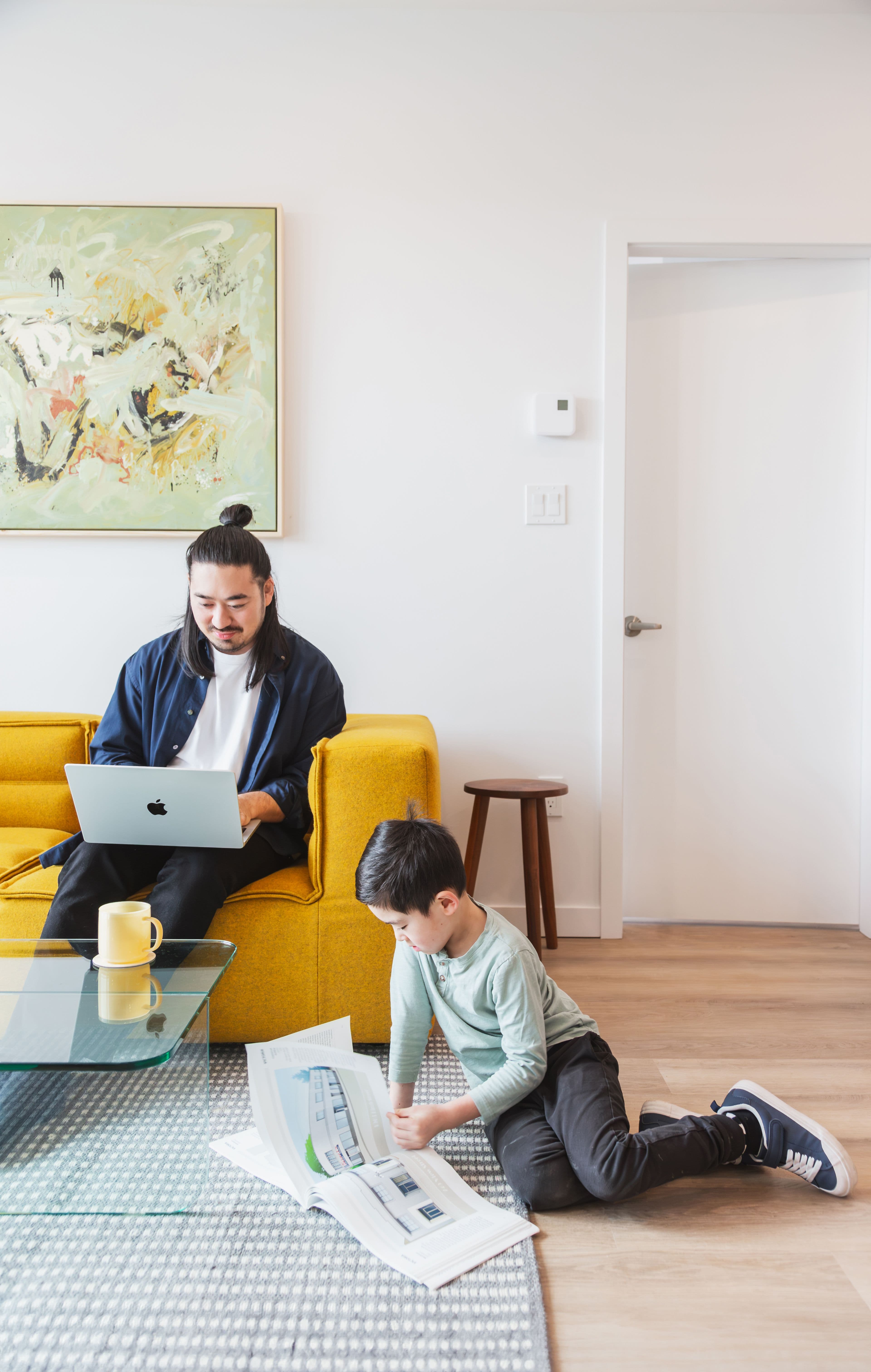 Woman in Centro apartment living room reading magazine